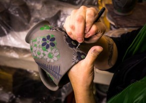carving a wheel-thrown clay mug